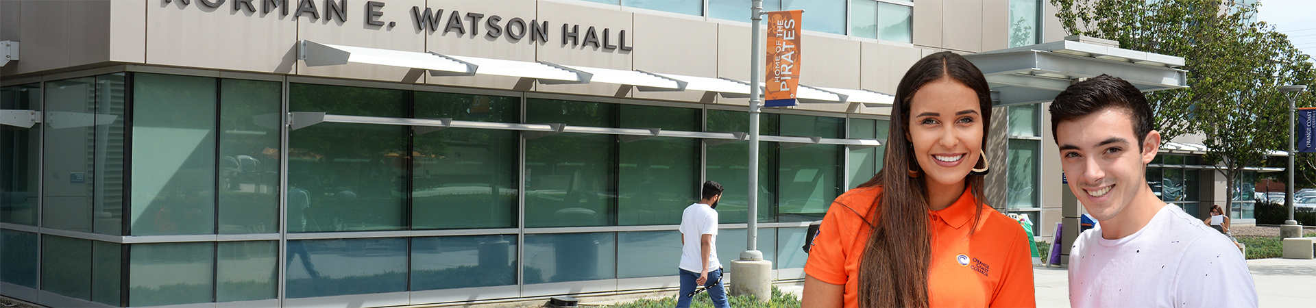 2 students in front of the enrollment center entrance