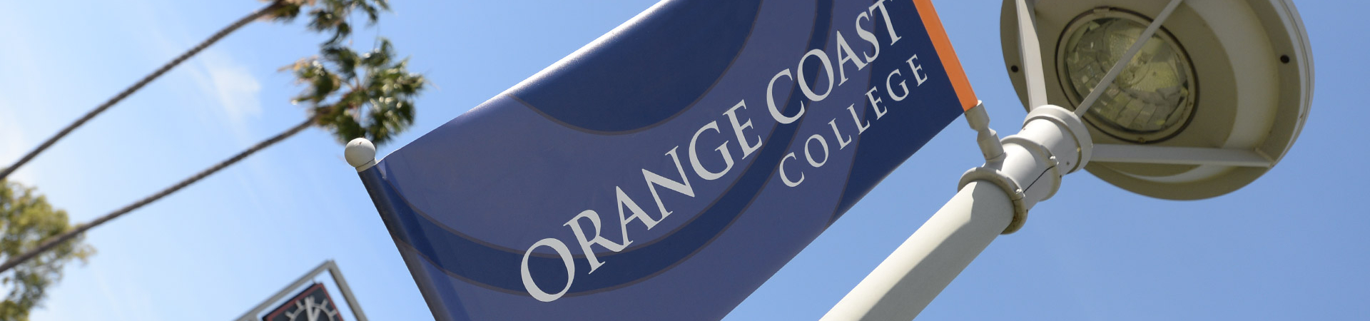 첥Ƶ Coast College spirt banner hanging on a lamp post.